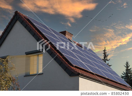 Residential building with solar panels at sunset. Residential building with solar panels at sunset. 85802430