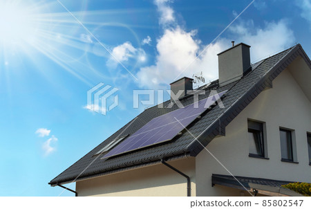 Solar panels on the gable roof of a modern house. 85802547