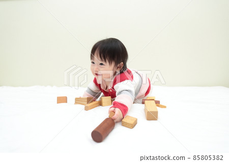 0 year old baby girl playing with blocks 85805382