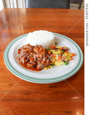 stewed pork ,pork with rice and sauce or rice topped with stew pork. 85807938
