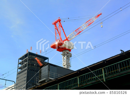 Giant crane working at a large-scale development construction site 85810326