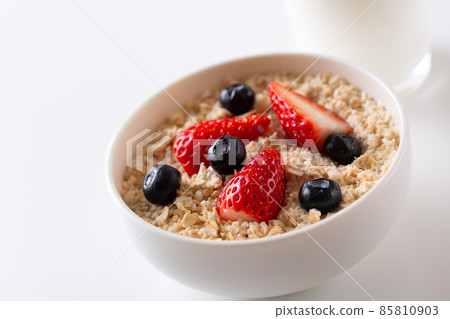 Oatmeal topped with strawberries and blueberries 85810903