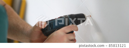 Hands of a man working with a screwdriver close up 85813121