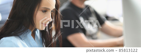 Call center team working at desks in the office 85813122