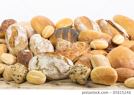 Many kinds and kinds of bread collected in one place on a wooden old shop counter as a decoration for a traditional bakery. White background from the top for self-completion. Many kinds and kinds of bread collected in one place on a wooden old shop counter as a decoration for a traditional bakery. White background from the top for self-completion. 85815248