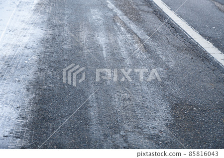 Roads sprayed with calcium chloride on a snowy day Roads sprayed with calcium chloride on a snowy day 85816043