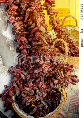 red dry hot chili peppers hanging on market for sale. Concept of street trade in spices 85816334