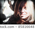 Contrast Sunlight and Shadows on the Face of a Smiling Young Blonde Woman 85816648