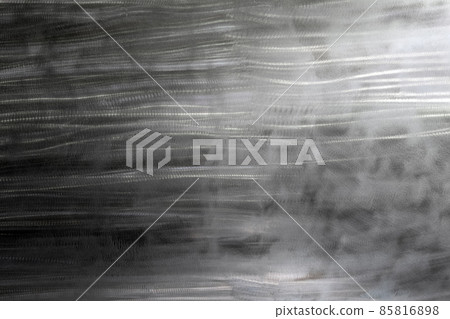 Close-up texture of flat steel surface manually cleaned with a flap wheel angle grinder. 85816898