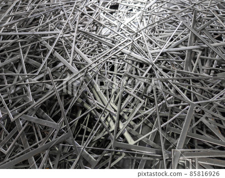 full frame abstract industrial background of stamping leftovers pile, close-up with selective focus 85816926