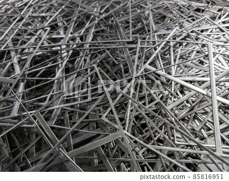 full frame abstract industrial background of stamping leftovers pile, close-up with selective focus 85816951