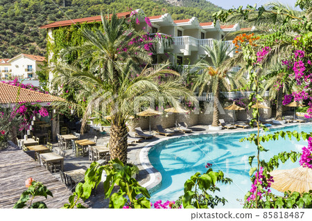 Luxury tropical resort or private villa with turquoise pool, sunbeds, umbrellas and palms. Relaxation and vacation concept Luxury tropical resort or private villa with turquoise pool, sunbeds, umbrellas and palms. Relaxation and vacation concept 85818487