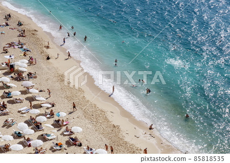 View of the turquoise beach. Beautiful Kaputas Beach Turkey with people resting under the sun and in the sea 85818535
