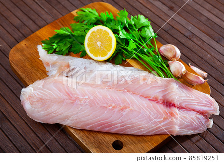 Image of fillet of raw perch fillet before cooking with greens 85819251