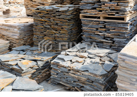 Pallets with natural stone tiles in a warehouse of brick factory 85819405