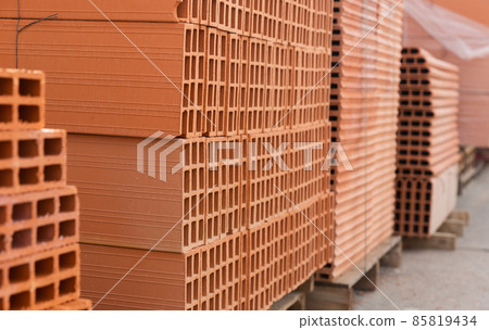 Pallets with stack of redbricks lying at warehouse Pallets with stack of redbricks lying at warehouse 85819434