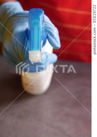 using disinfectant spray to clean table surface using disinfectant spray to clean table surface 85819722