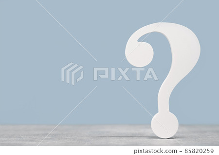 White question mark symbol on a gray desk on blue 85820259