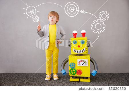 Happy child playing with robot 85820850