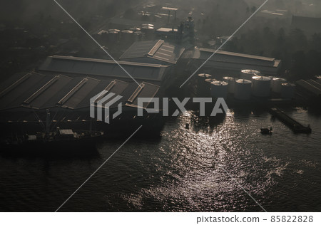 Aerial view overlooking of Oil and gas refinery industrial factory, Pier and Cargo ship along Chao phraya river. Aerial view overlooking of Oil and gas refinery industrial factory, Pier and Cargo ship along Chao phraya river. 85822828