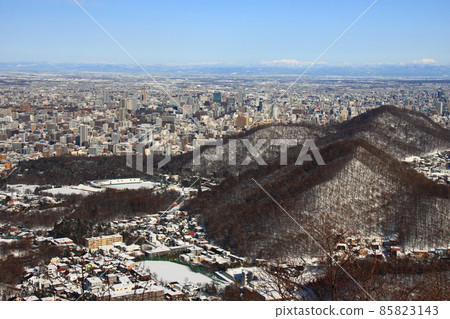 Sapporo city area and distant mountain range seen from Mt. Okusan in winter 85823143