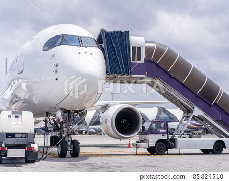 Airplane near the terminal in an airport 85824510