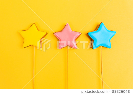 Colorful glazing cookies on a yellow background. Decorating desserts. Cake decorating tools. Confectionery concept. Flat lay. Colorful glazing cookies on a yellow background. Decorating desserts. Cake decorating tools. Confectionery concept. Flat lay. 85826048