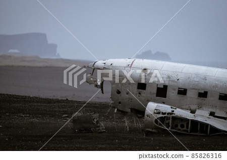 Wreck of and airplane profile, foggy day Wreck of and airplane profile, foggy day 85826316