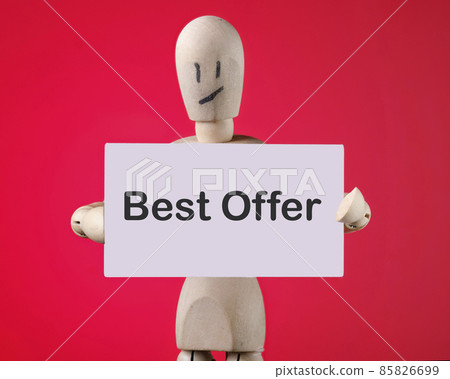 A wooden man holds a card with phrase Best offer. Business Concept A wooden man holds a card with phrase Best offer. Business Concept 85826699