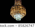 Contemporary glass chandelier isolated over black background 85826747