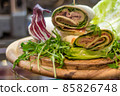 wrap sandwich with ham, lettuce, ruccola and cheeses 85826748