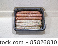 Fresh peppered raw sausages ready for frying 85826830