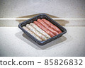 Fresh peppered raw sausages ready for frying 85826832