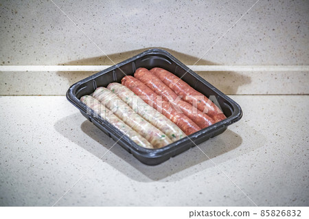 Fresh peppered raw sausages ready for frying 85826832