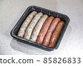 Fresh peppered raw sausages ready for frying 85826833