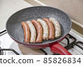 Fresh peppered raw sausages ready for frying 85826834