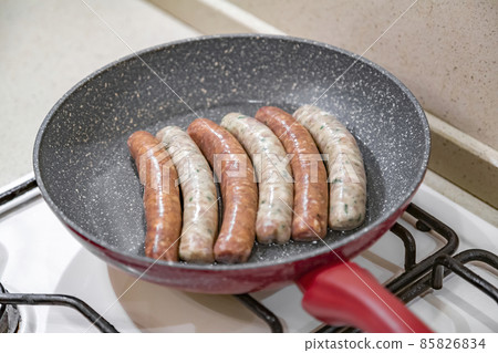 Fresh peppered raw sausages ready for frying 85826834