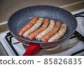 Fresh peppered raw sausages ready for frying 85826835