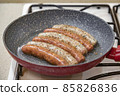 Fresh peppered raw sausages ready for frying 85826836