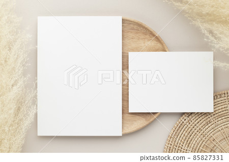 Blank paper cards, Mockup with pampas grass on a wooden plate, beige background, Minimal beige workplace composition, flat lay, mockup Blank paper cards, Mockup with pampas grass on a wooden plate, beige background, Minimal beige workplace composition, flat lay, mockup 85827331