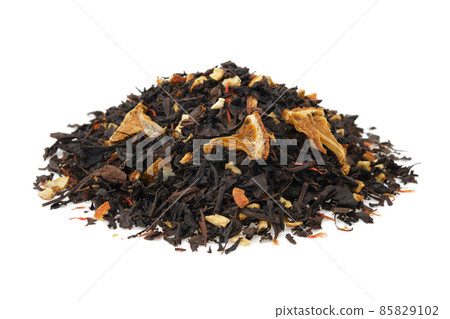 Pile of dry black tea leaves on white. Heap of aromatic black tea leaves with dried citrus slices and peel. 85829102