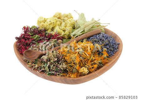 Wooden plate of medicinal herbs, isolated on white. Healing plants, ingredients for making of herbal medicine drugs, tea or infusion. Alternative and herbal medicine concept. 85829103