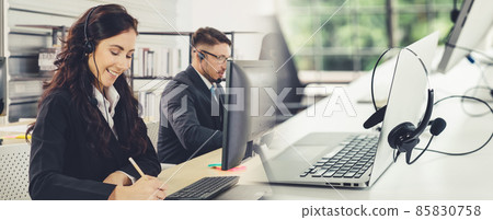 Business people wearing headset working in office broaden view Business people wearing headset working in office broaden view 85830758