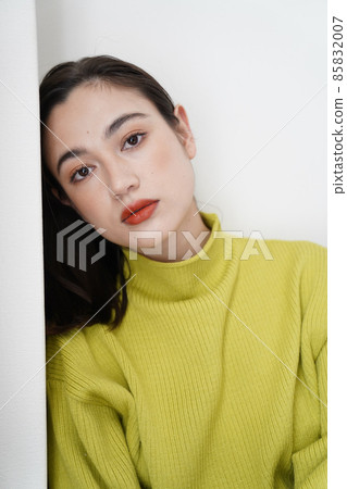 Female in yellow knit 85832007