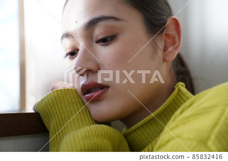 Female in a yellow knit 85832416