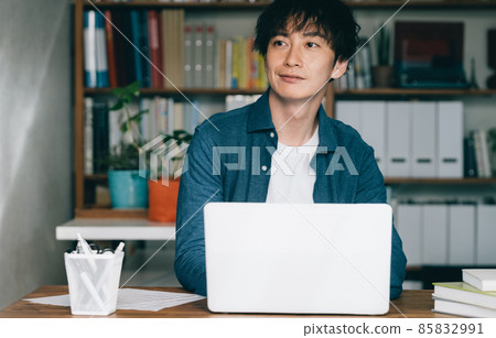 A man refreshing in front of a computer A man refreshing in front of a computer 85832991
