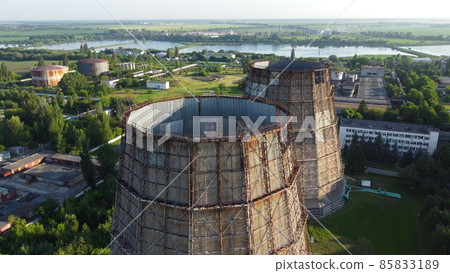 Aerial drone view flight near thermal power plant. Cooling towers of CHP Aerial drone view flight near thermal power plant. Cooling towers of CHP 85833189
