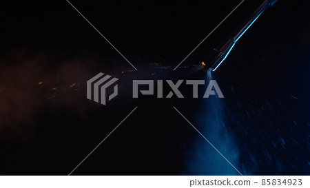 purging steam wand of coffee machine under neon lighting 85834923