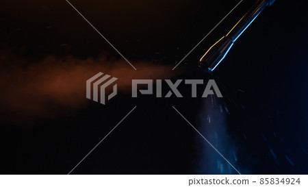 purging steam wand of coffee machine under neon lighting 85834924