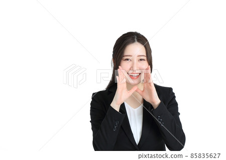 A woman wearing a suit and putting her hand on her mouth A woman wearing a suit and putting her hand on her mouth 85835627